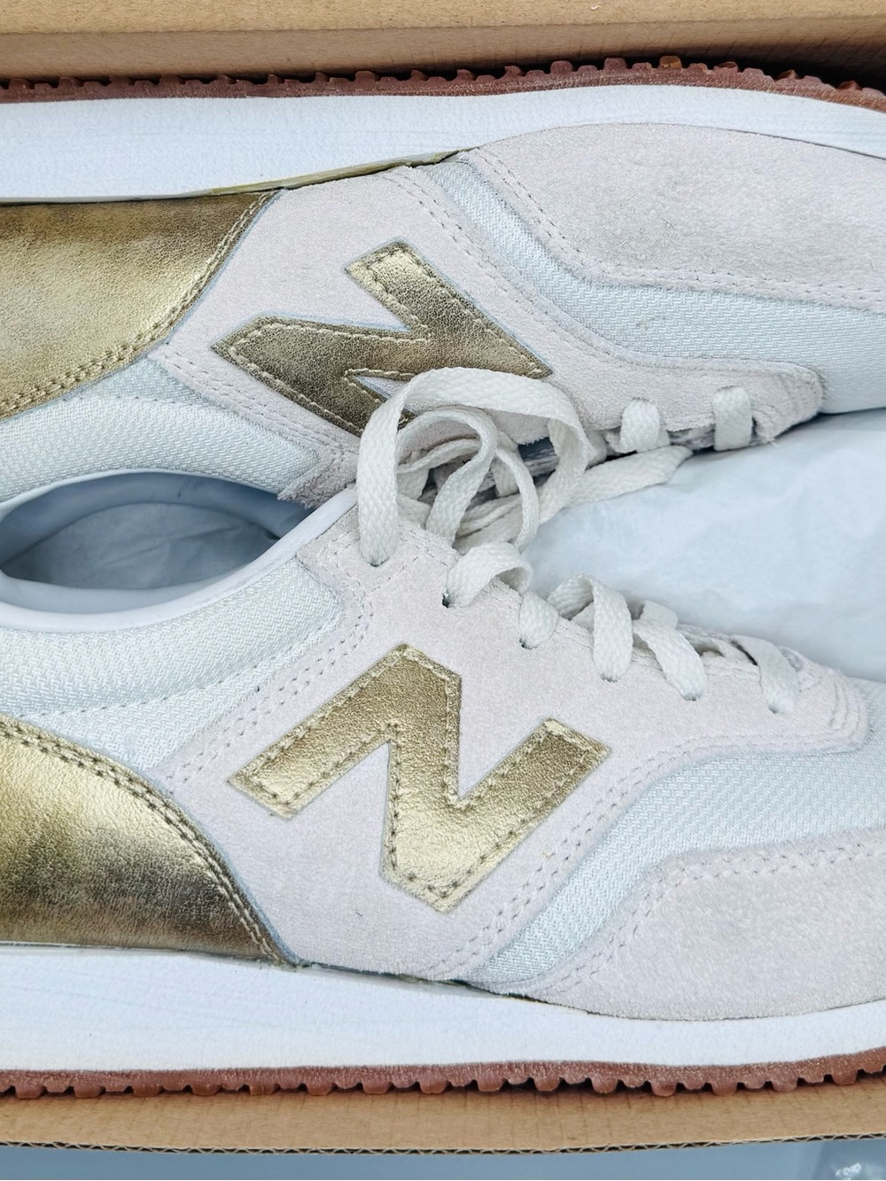 New Balance Women’s White Sneakers with Gold Accents